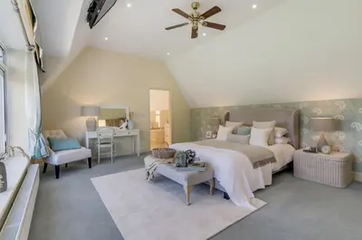 a bedroom with a large bed and a desk at 5 Bedroom House in Larling, near Thetford in Norwich