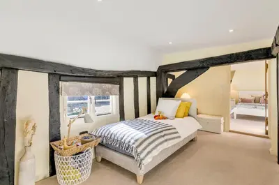 a bedroom with a large bed and a room with at 5 Bedroom House in Larling, near Thetford in Norwich