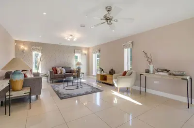 a living room with a couch and a table at 5 Bedroom House in Larling, near Thetford in Norwich
