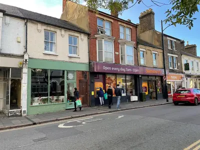 a group of shops on a city street at Cosy central 1 bedroom flat near city centre & station in Cambridge
