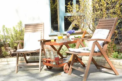 two chairs and a table on a patio at Yew Tree Farm Barn, Worlingworth in Worlingworth