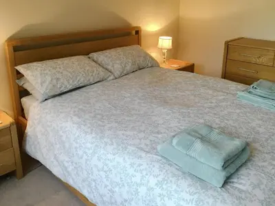 a bedroom with a bed with a blue towel on it at Hedgeways in Fordham