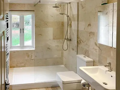 a bathroom with a shower and a toilet and a sink at Hedgeways in Fordham