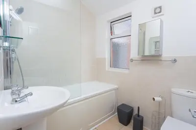a bathroom with a sink and a tub and a toilet at The White & Warm, Free Parking & Wifi, 8 beds in Colchester