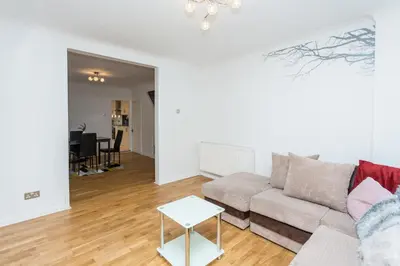 a living room with a couch and a table at The White & Warm, Free Parking & Wifi, 8 beds in Colchester