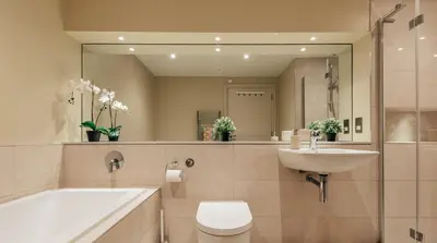 a bathroom with a sink toilet and a mirror at Willow Cottage at Gravel Farm in Stretham