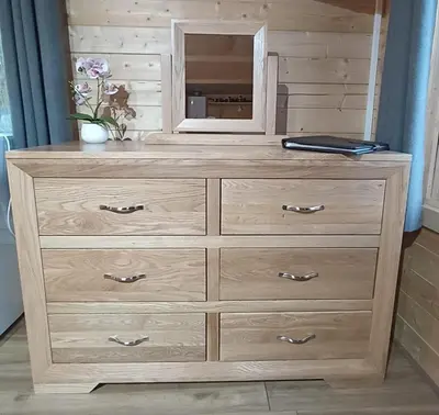 a wooden dresser with a mirror on top of it at Cosy Cabin in Stock