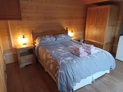 a bedroom with a bed with two stuffed animals on it at Cosy Cabin in Stock