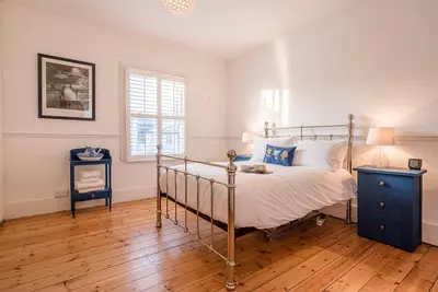 a bedroom with a bed and a wooden floor at 232a High Street, Aldeburgh in Aldeburgh