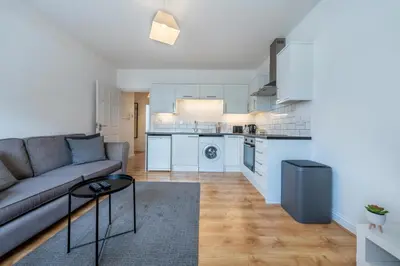 a living room with a couch and a kitchen at 2BR Apartment Near Stansted Airport & Bishop Stortford in Bishops Stortford