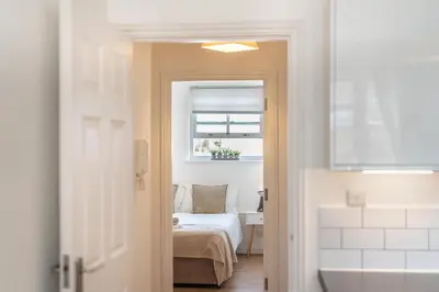 a bedroom with a bed and a window at 2BR Apartment Near Stansted Airport & Bishop Stortford in Bishops Stortford