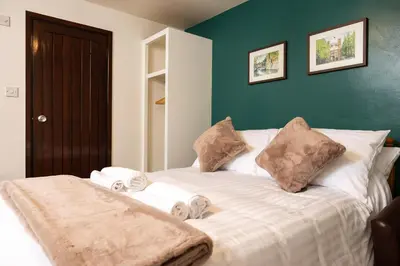 a bedroom with a bed with towels on it at The Black Horse in Swaffham Bulbeck