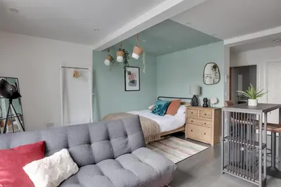 a living room with a couch and a bed at Studio Apartment - Central Chelmsford Location in Chelmsford