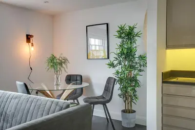 a living room with a couch and a table and plants at Cosy Chelmsford Apartment - Free Allocated Parking in Chelmsford