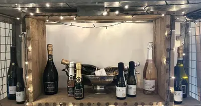 a shelf with bottles of wine and a bowl at The Half Moon Inn Rushall IP21 4QD in Pulham Saint Mary the Virgin