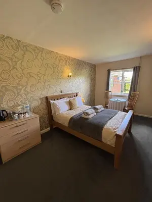 a bedroom with a large bed and a window at The Half Moon Inn Rushall IP21 4QD in Pulham Saint Mary the Virgin