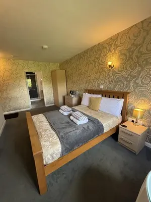 a bedroom with a bed with two towels on it at The Half Moon Inn Rushall IP21 4QD in Pulham Saint Mary the Virgin