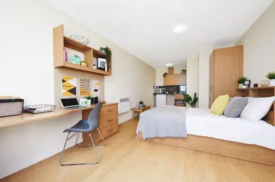 a bedroom with a bed and a desk and a chair at For Students Only Collegiate Athena Hall Ipswich in Ipswich