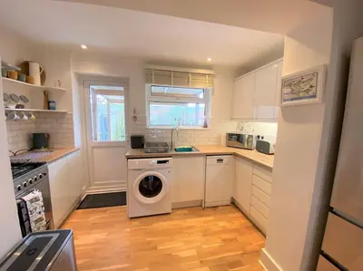 a kitchen with a washer and dryer in it at Gulliver's Cottage in Frinton-On-Sea in Frinton-on-Sea