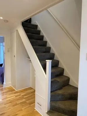 a staircase in a house with a stair case at Gulliver's Cottage in Frinton-On-Sea in Frinton-on-Sea