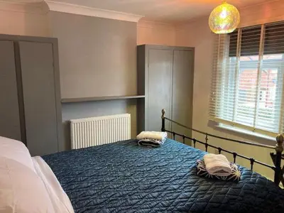a bedroom with a bed with two pillows on it at Gulliver's Cottage in Frinton-On-Sea in Frinton-on-Sea