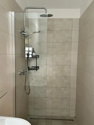 a bathroom with a shower with a glass door at The Peacock Inn in Chelsworth