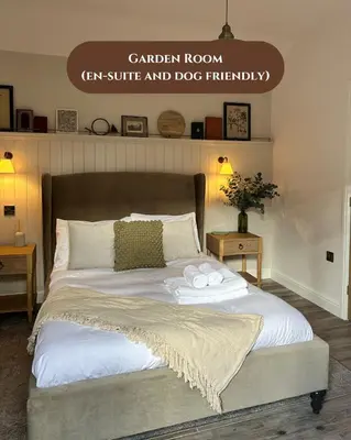 a bedroom with a bed with two towels on it at The Peacock Inn in Chelsworth