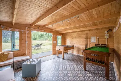 a room with a pool table in a wooden room at The Hayloft Boundary Farm, Framlingham in Woodbridge