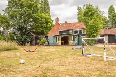 a yard with a soccer ball and a goal at The Cartlodge Boundary Farm, Framlingham in Woodbridge
