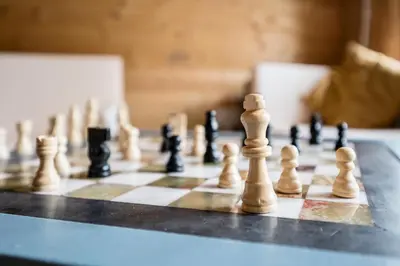 a chess board with chess pieces on a table at Sage Shepherds Hut Boundary Farm, Framlingham in Woodbridge