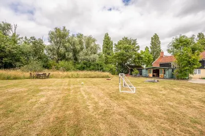 a yard with a soccer ball and a goal at Sage Shepherds Hut Boundary Farm, Framlingham in Woodbridge