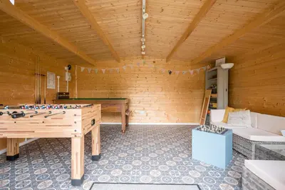 a room with a ping pong table in a room at Sage Shepherds Hut Boundary Farm, Framlingham in Woodbridge