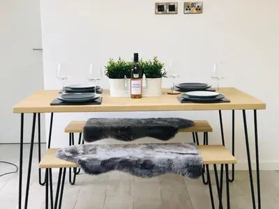 a dining room table with a coat of fur on it at 2 Bedroom Garden Studio in Cambridge City Centre with Parking in Cambridge