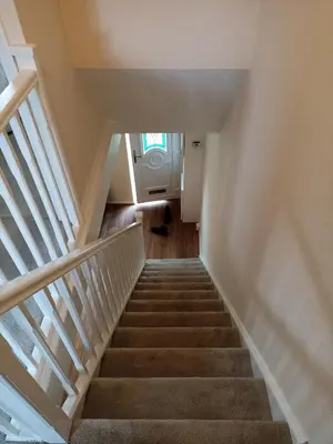 a staircase leading up to the basement of a house at Comfortable Billericay Home in Billericay
