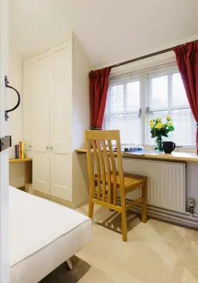 a kitchen with a chair and a desk in a room at Lavender Cottage in Thorndon