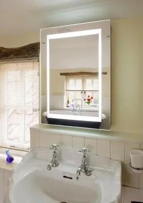 a bathroom with a white sink and a mirror at Lavender Cottage in Thorndon