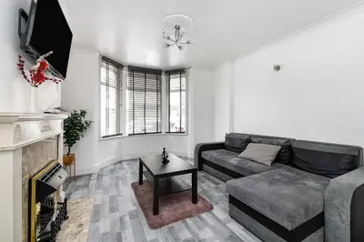 a living room with a couch and a fireplace at The White Rose Crown, Free Parking & Wifi, 10beds in Colchester