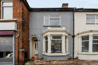 a brick house with a white window at The White Rose Crown, Free Parking & Wifi, 10beds in Colchester