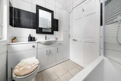 a white bathroom with a sink and a toilet at The White Rose Crown, Free Parking & Wifi, 10beds in Colchester