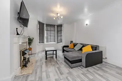 a living room with a couch and a fireplace at The White Rose Crown, Free Parking & Wifi, 10beds in Colchester