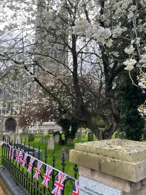 a cemetery with british flags on a fence at Loft in Bungay in Bungay