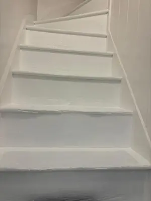 a set of white stairs in a room at Loft in Bungay in Bungay
