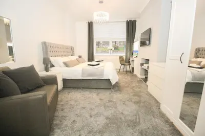 a bedroom with a bed and a couch at Roman Quarter in Colchester