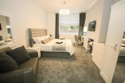 a bedroom with a bed and a couch at Roman Quarter in Colchester