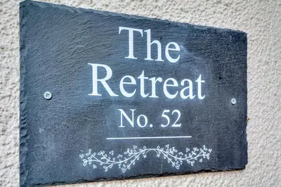 a black sign that reads the retreat no at The Retreat on Risbygate in Bury Saint Edmunds