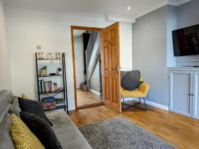 a living room with a couch and a mirror at The Retreat on Risbygate in Bury Saint Edmunds