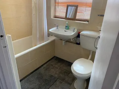 a small bathroom with a toilet and a sink at Hikers & Bikers Refuge in Ipswich