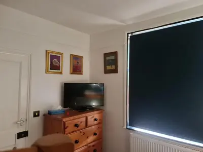 a living room with a large window and a television at Hikers & Bikers Refuge in Ipswich