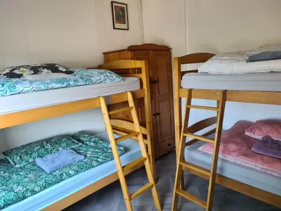 a room with two bunk beds and a ladder at Hikers & Bikers Refuge in Ipswich