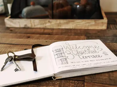 a book with a pair of scissors sitting on a table at 3 Chestnut Terrace by The Suffolk Cottage Collection in Long Melford
